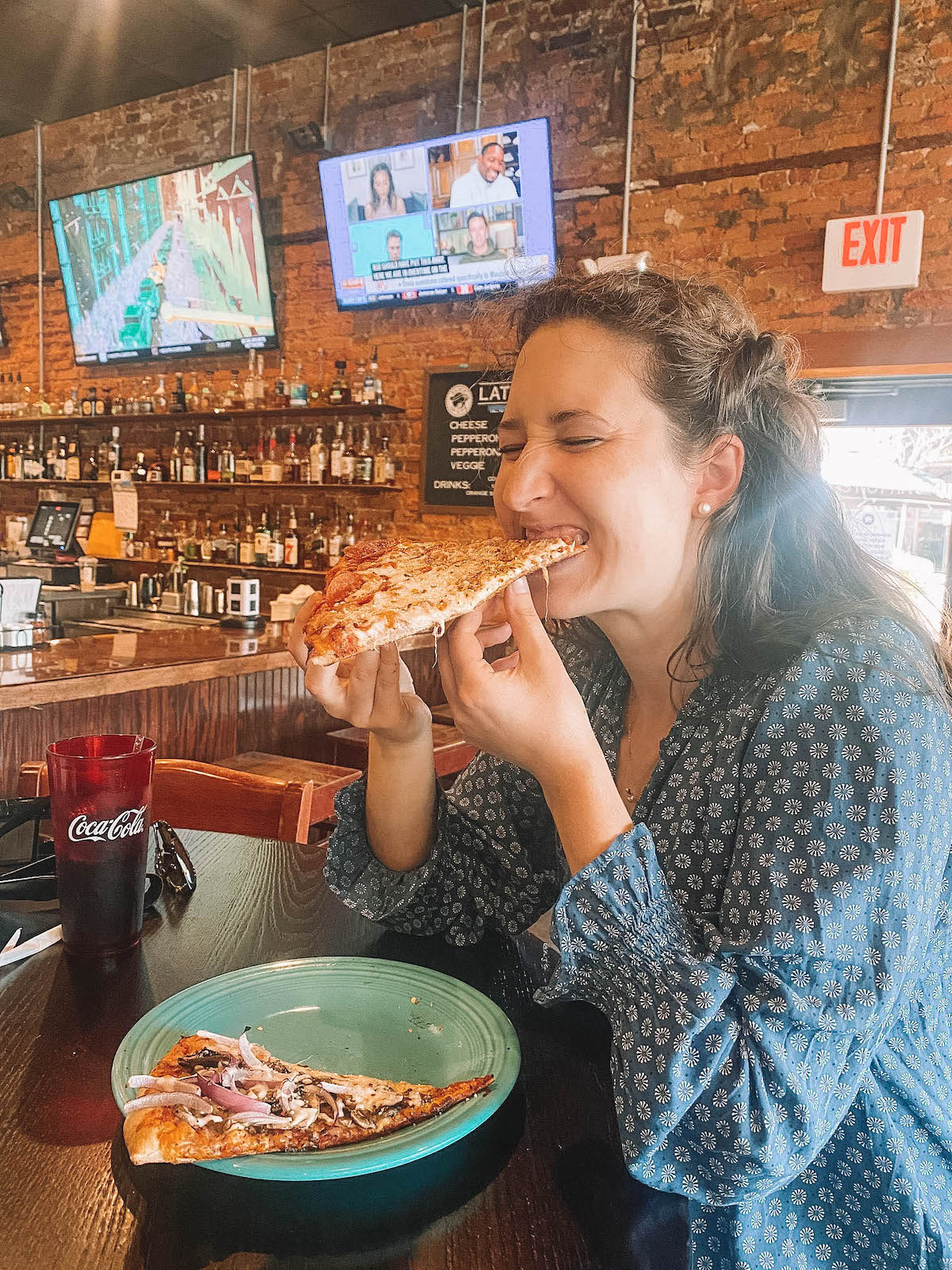 Woman eating a slice of hot pizza. 