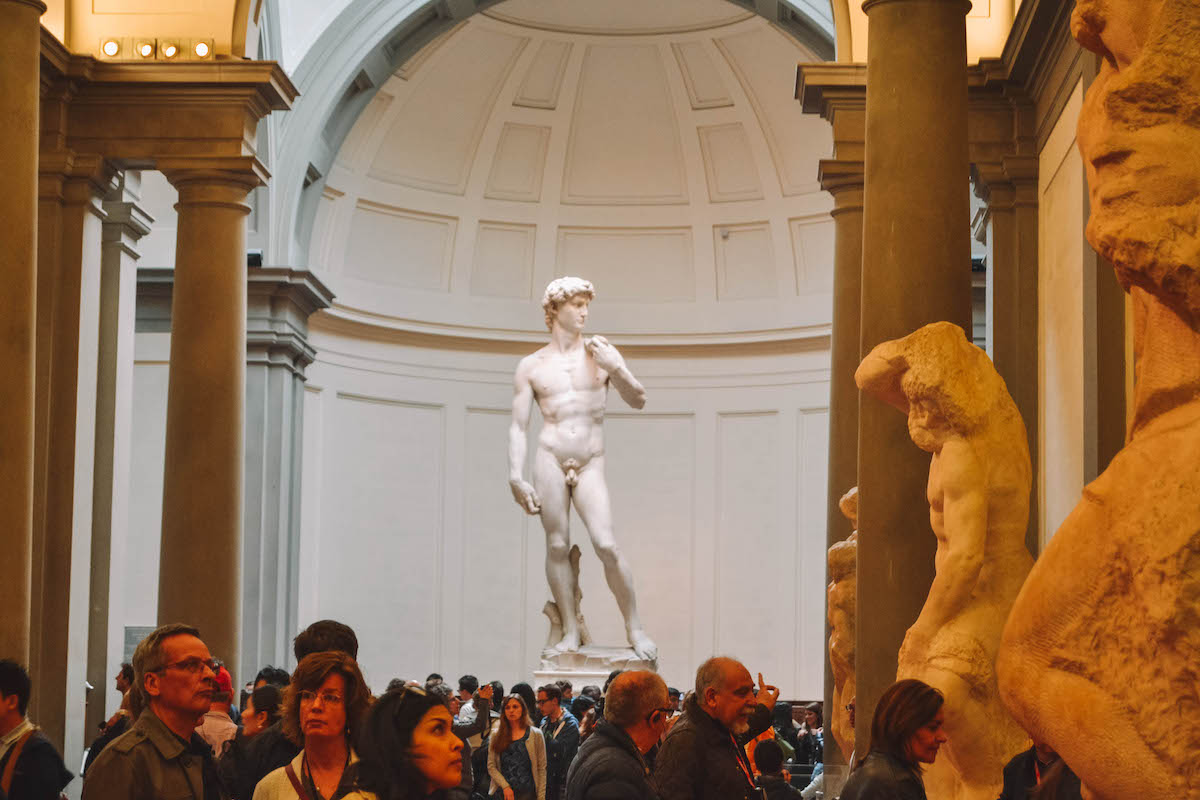 Michelangelo's "David," seen above a crowd of people
