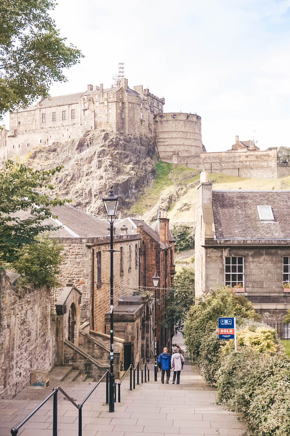 A winding staircase, with Edinburgh Castle looming in the background. 