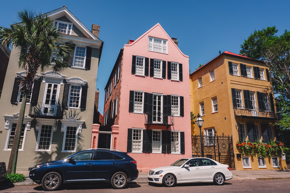 Three pastel-colored houses along Charleston's Rainbow Row. 