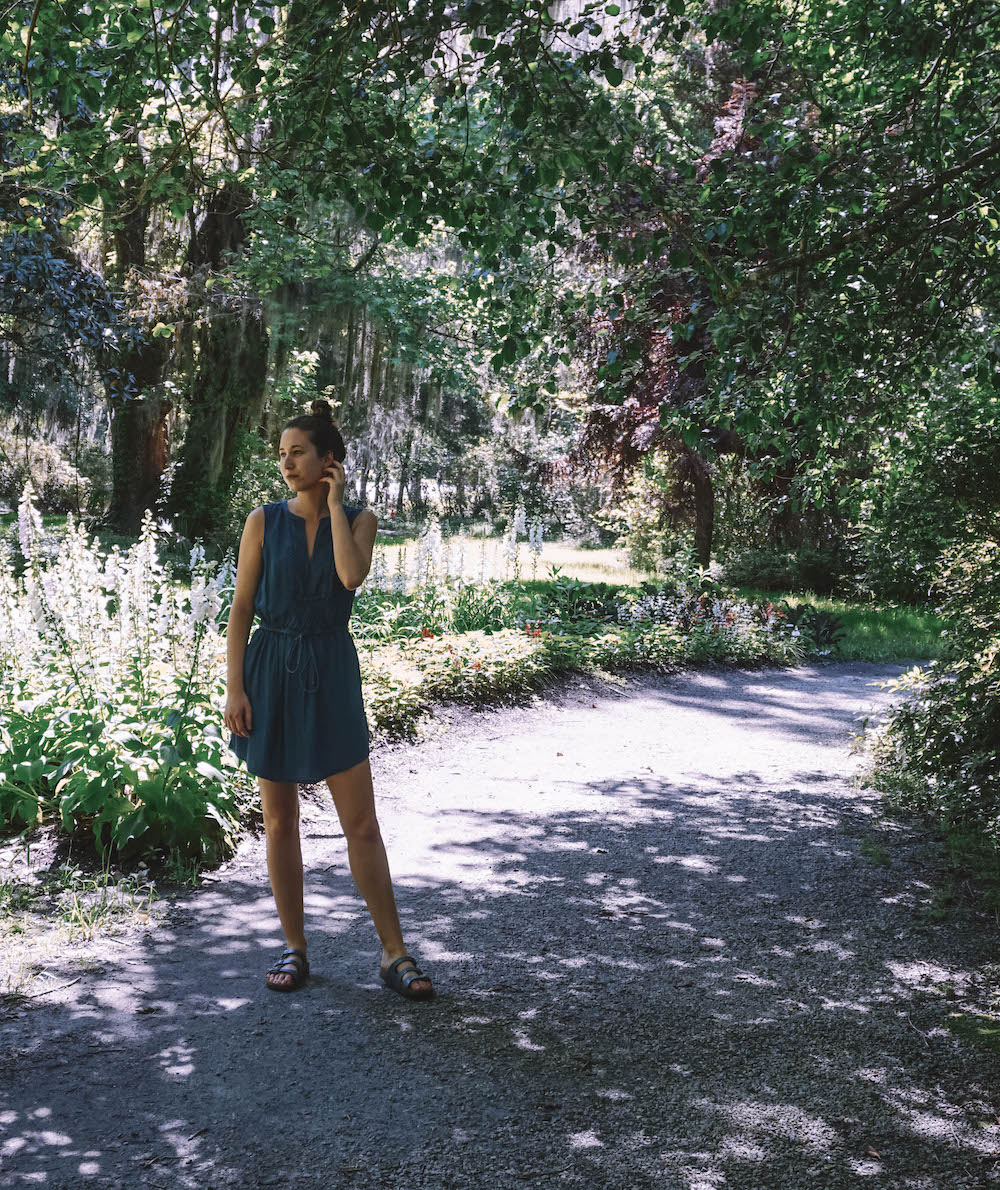 A woman standing in the gardens of Magnolia Plantation in Charleston, SC.