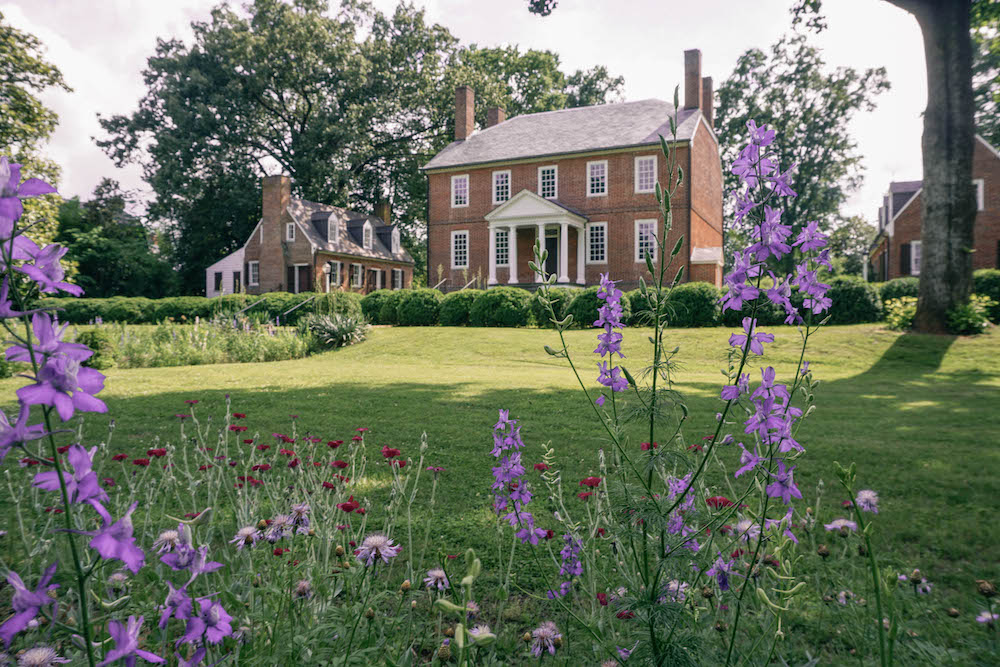 Front view of Kenmore Plantation. Flowers are in the foreground. 