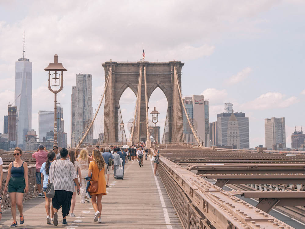 A view down the Brooklyn Bridge, with the Manhattan skyline in the distance. 