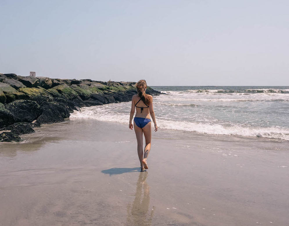 Woman walking along Long Beach NYC