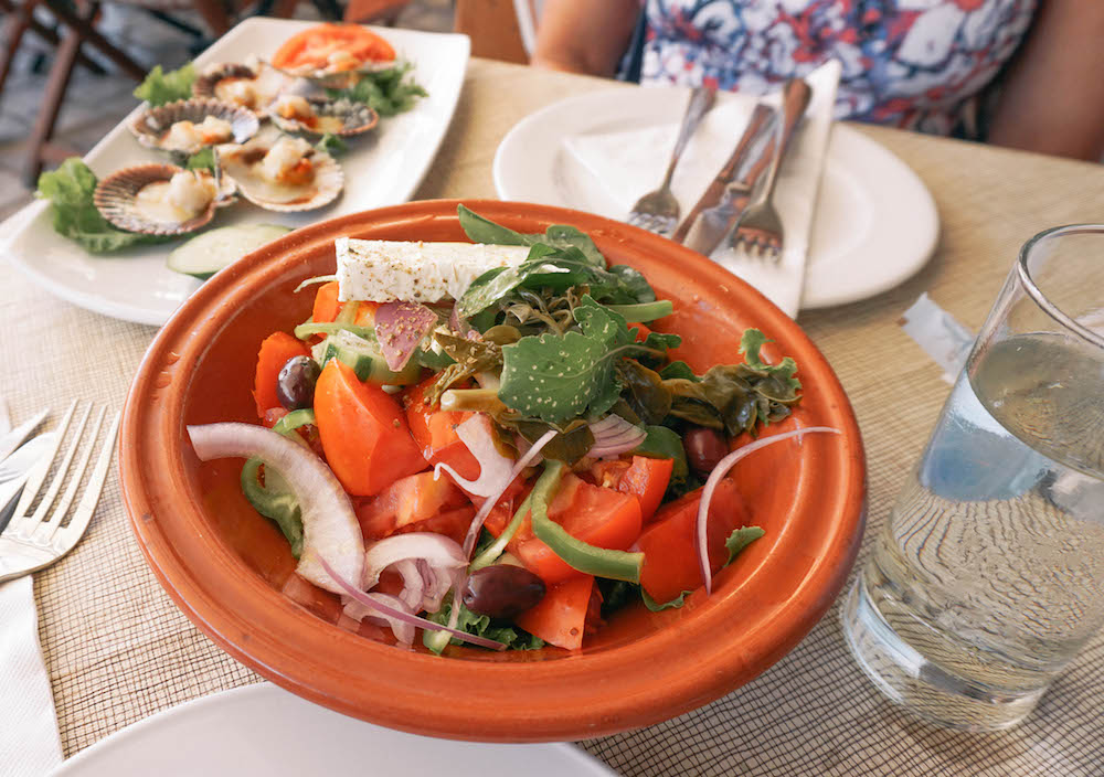 A Greek salad on a red plate. 