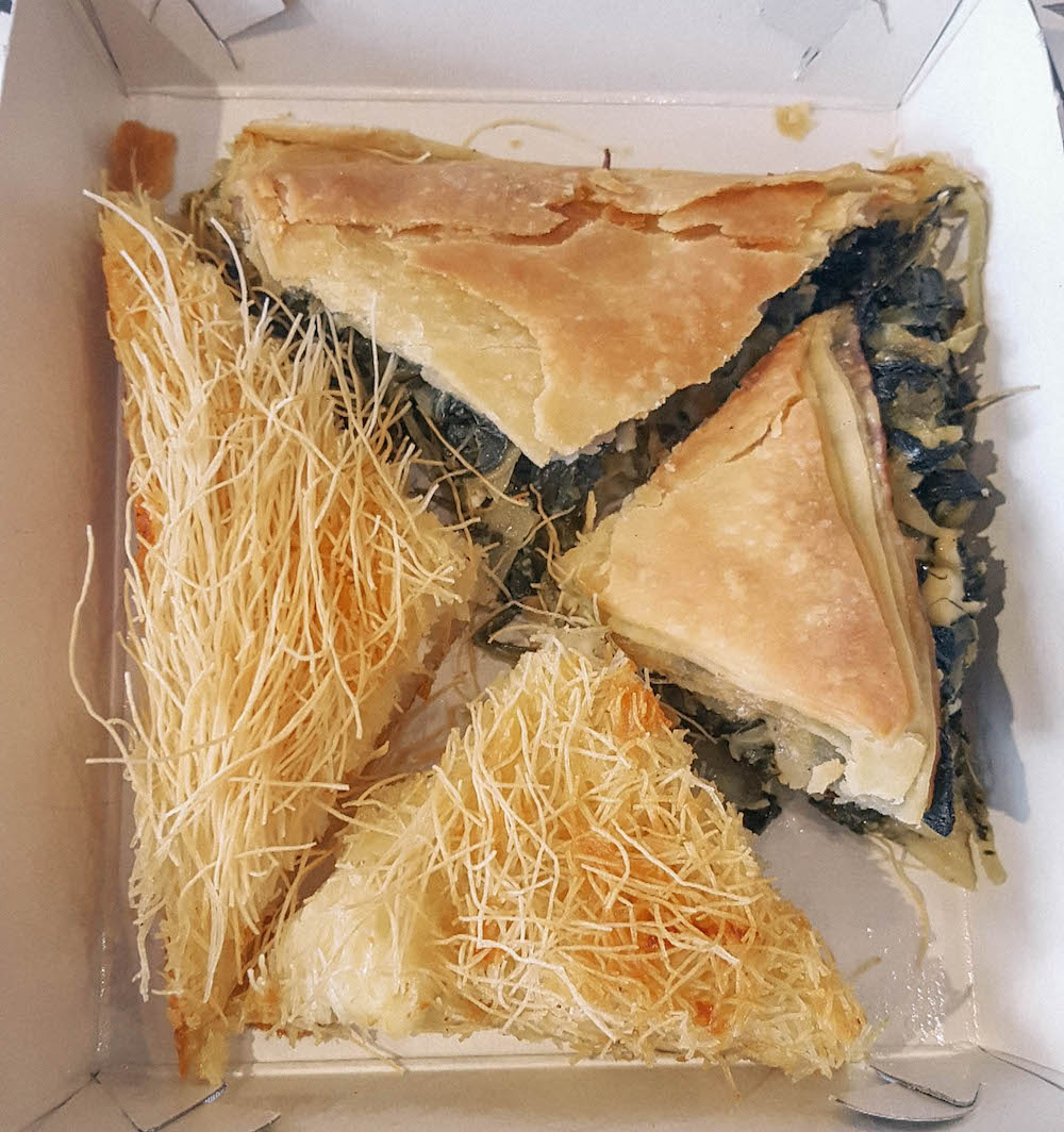 Overhead view of four pieces of Spanakopita. 