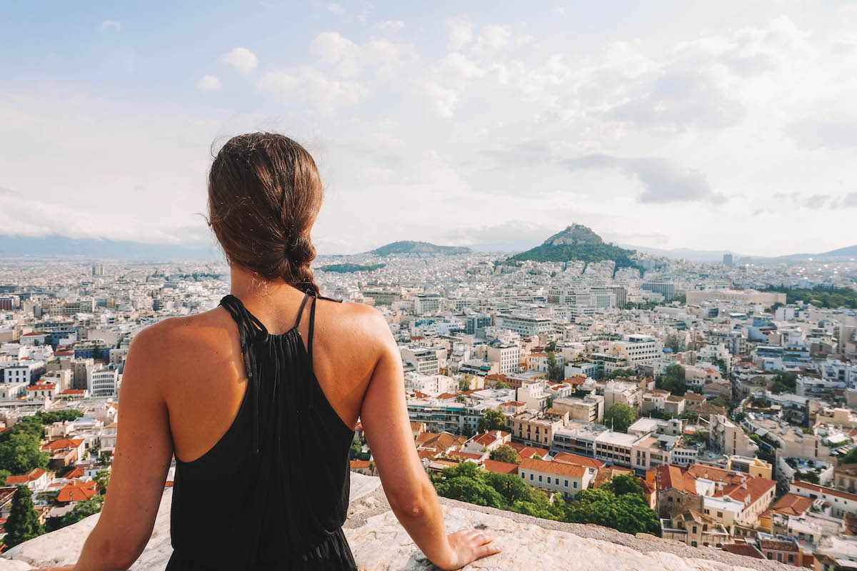 A woman facing Mount Lycabettus, seen from the top of Acropolis Hill.