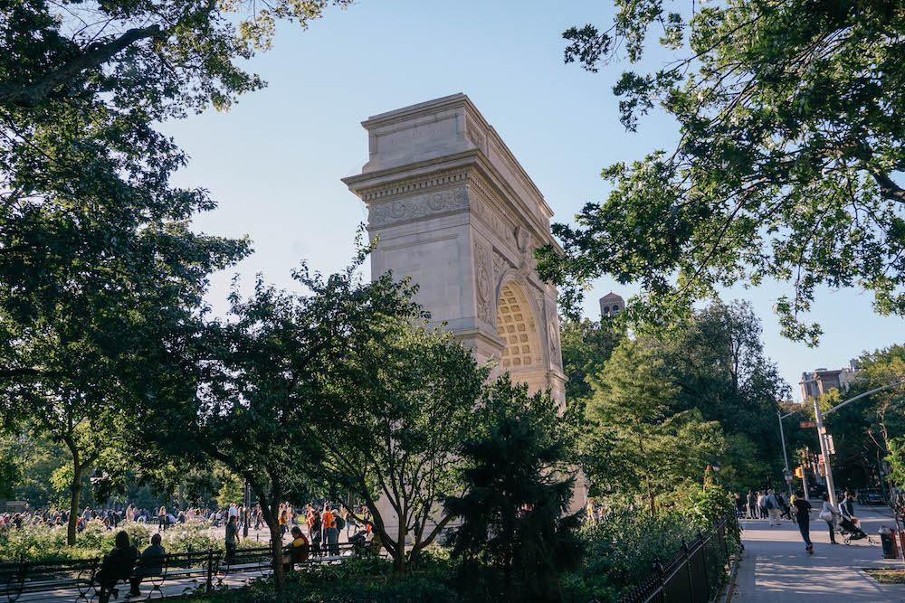 Side view of the arch in Washington Square Park NYC. The trees are all blooming.
