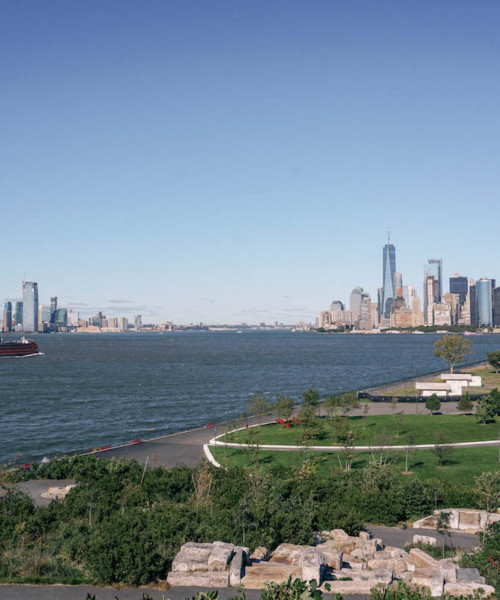 A view of Governors Island, from top of a hill. FiDi skyline is in the distance.