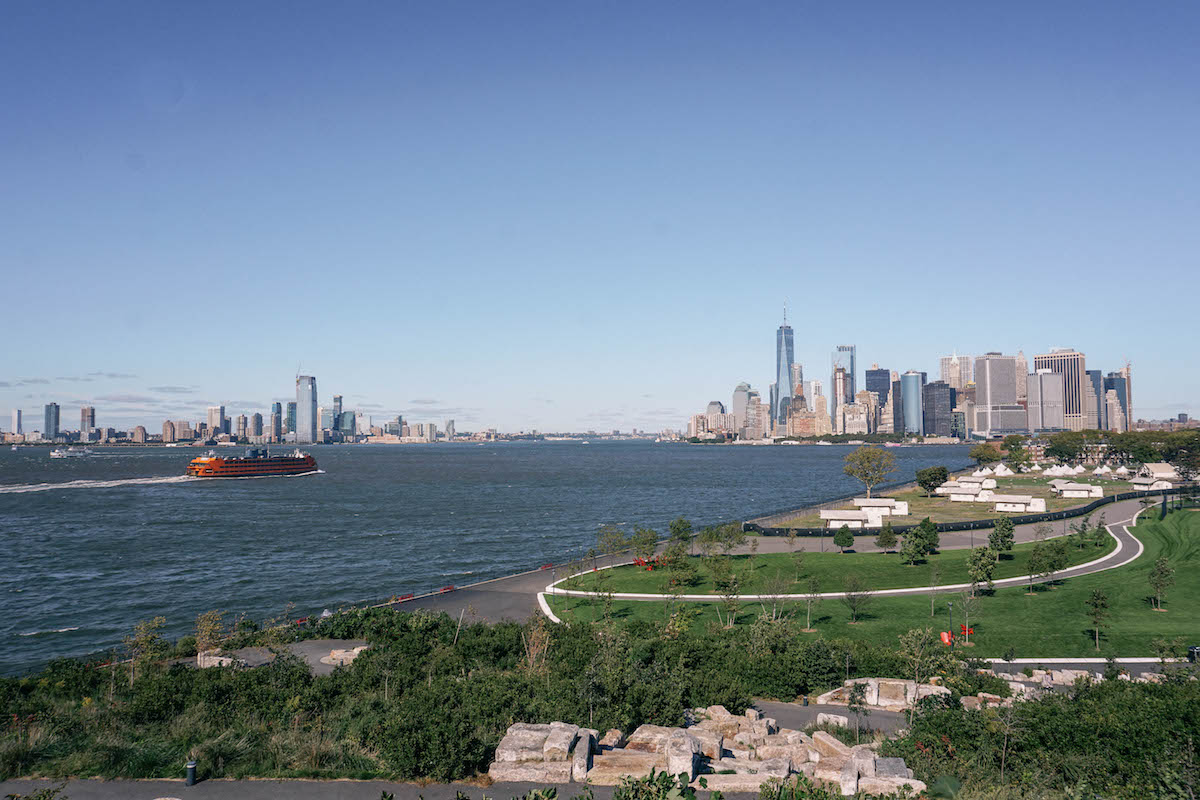 A view of Governors Island, from top of a hill. FiDi skyline is in the distance.