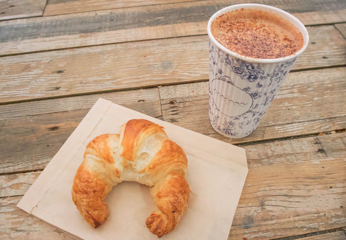 croissant and hot chocolate on wooden table
