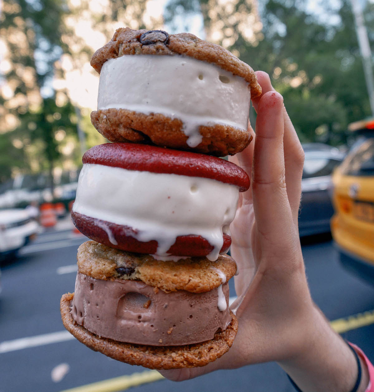 Three ice cream sandwiches held in a stack