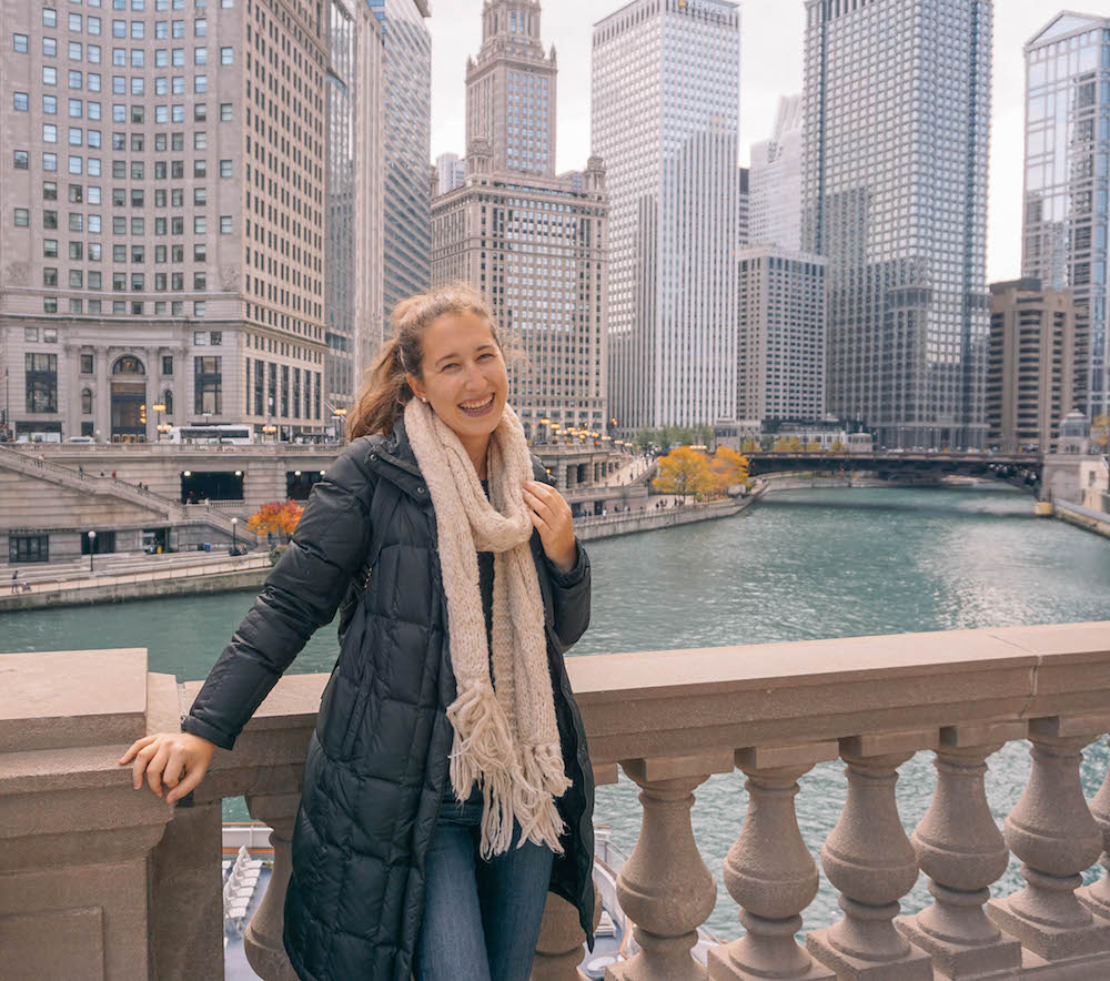 Woman smiling with Chicago skyscrapers in the background. 