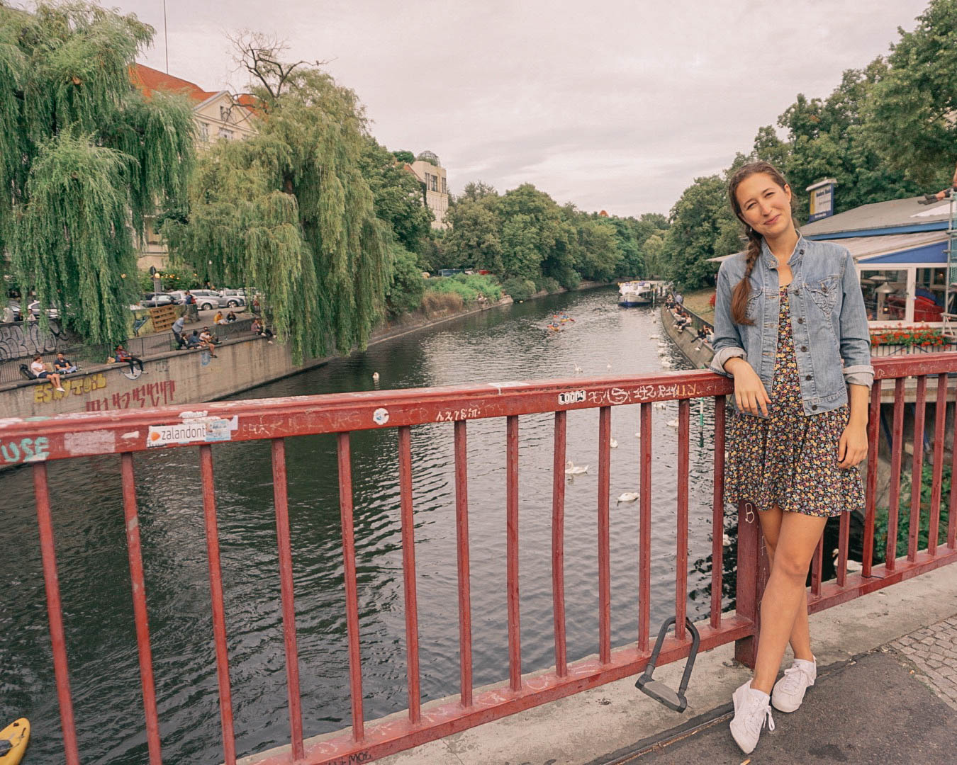 Woman standing on bridge over Berlin canal
