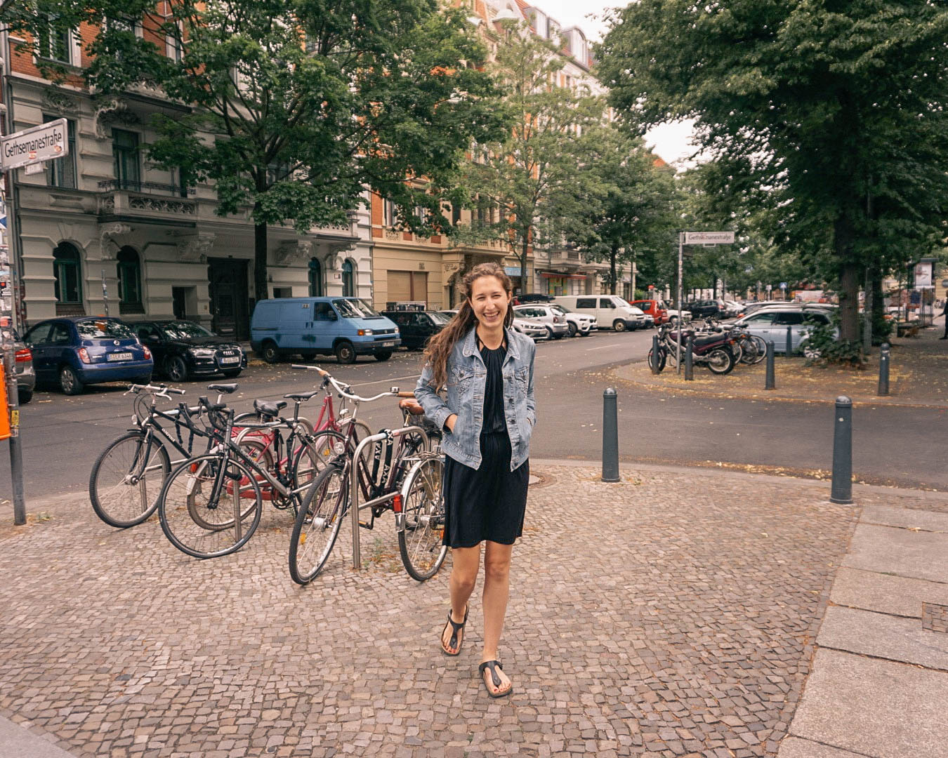 A woman smiling on a street in Berlin. 