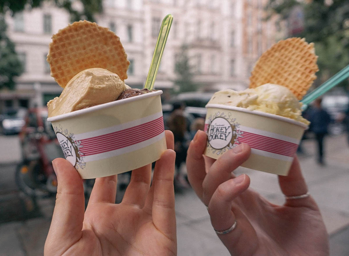 Two bowls of Hokey Pokey ice cream being held aloft. 