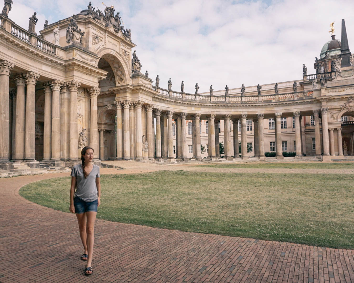 A woman posing in front of a building in Sanssouci Park in Potsdam. 