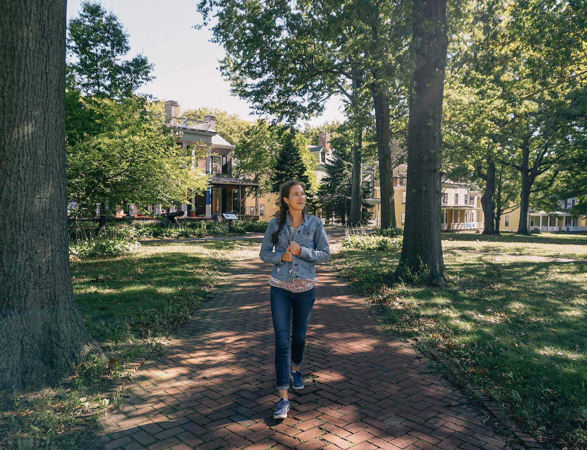 Woman walking along path on Governors Island in NYC.