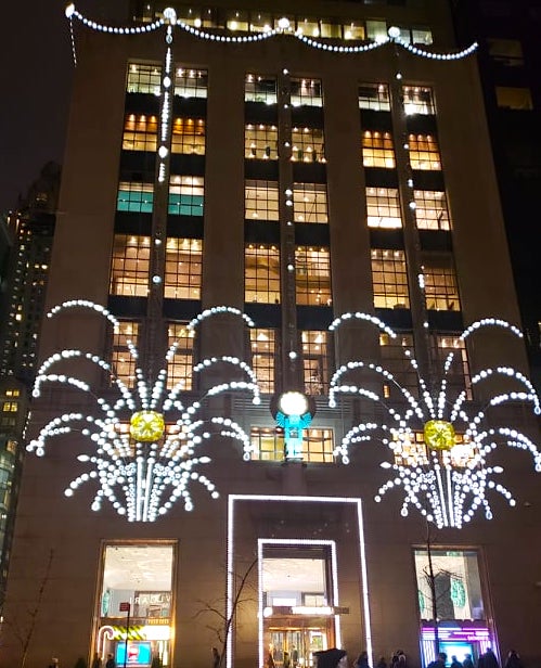 The Tiffany & Co. building on Fifth Avenue lit up with Christmas lights. 