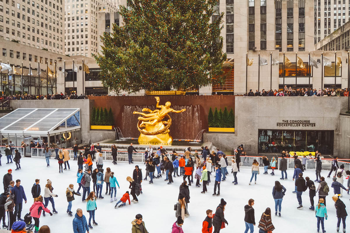 Ice rink at Rockefeller Center, beneath a large Christmas Tree. 