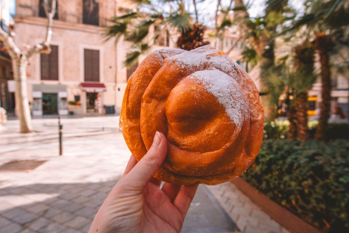 A Mallorcan ensaimada being held up