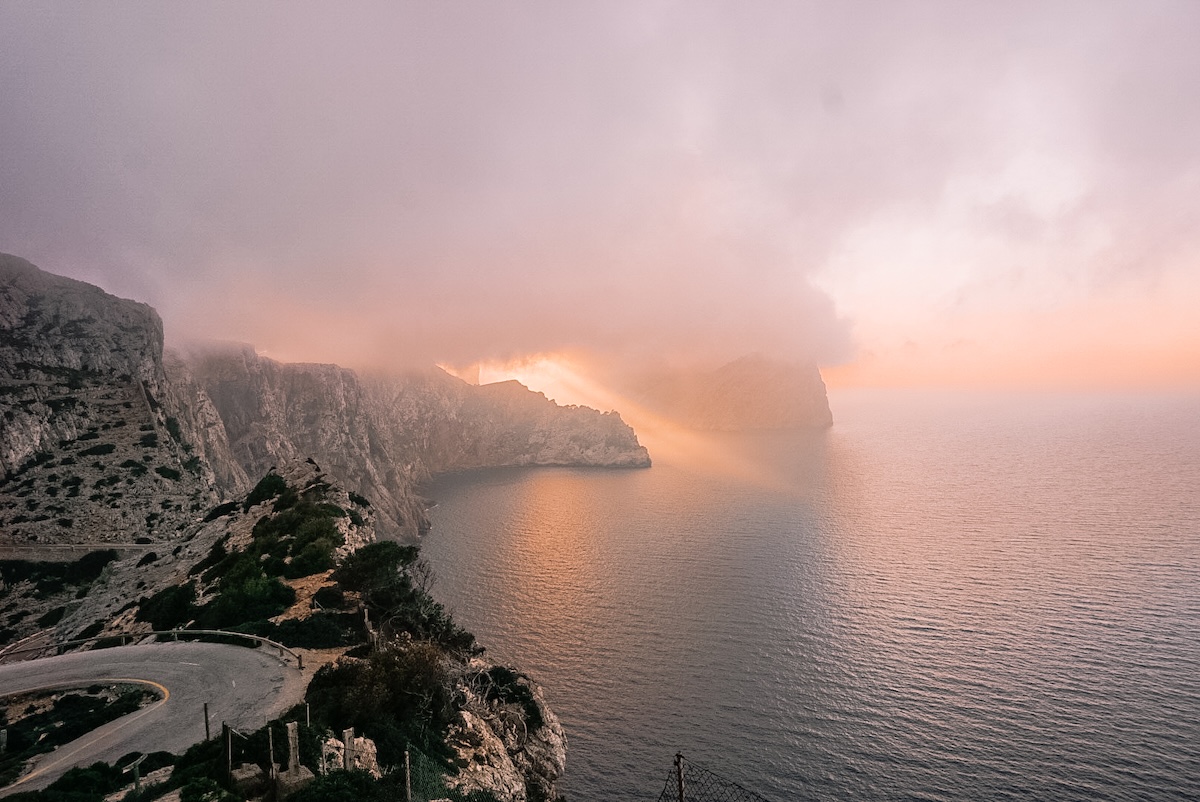 A foggy sunset view from the Cap de Formentor Lighthouse.