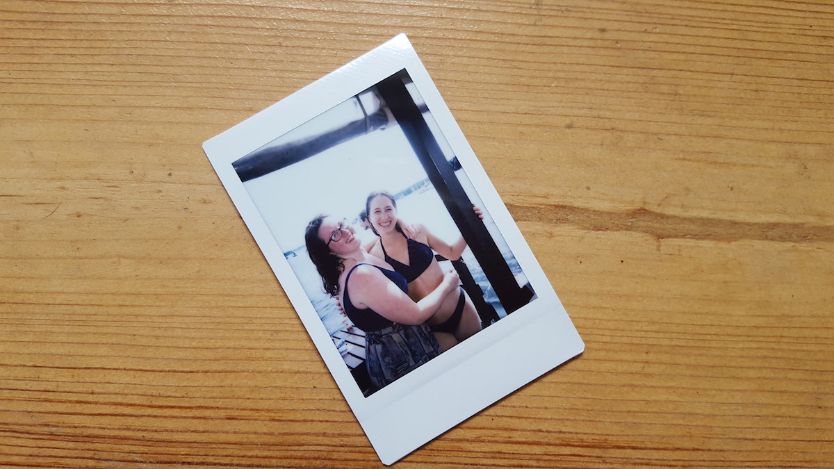 A polaroid photo of two women on a boat on a Berlin lake.