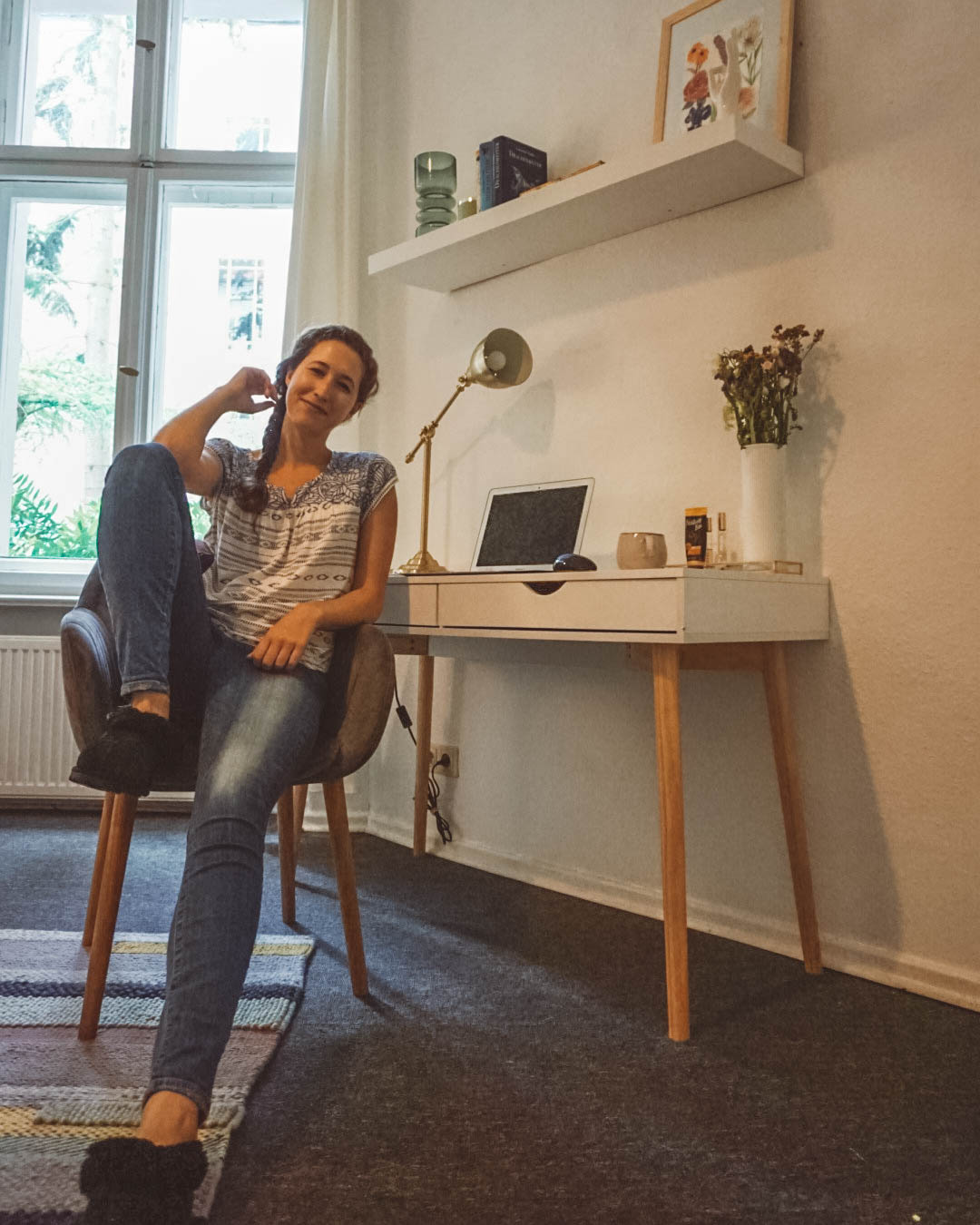 woman sitting in purple armchair in front of desk