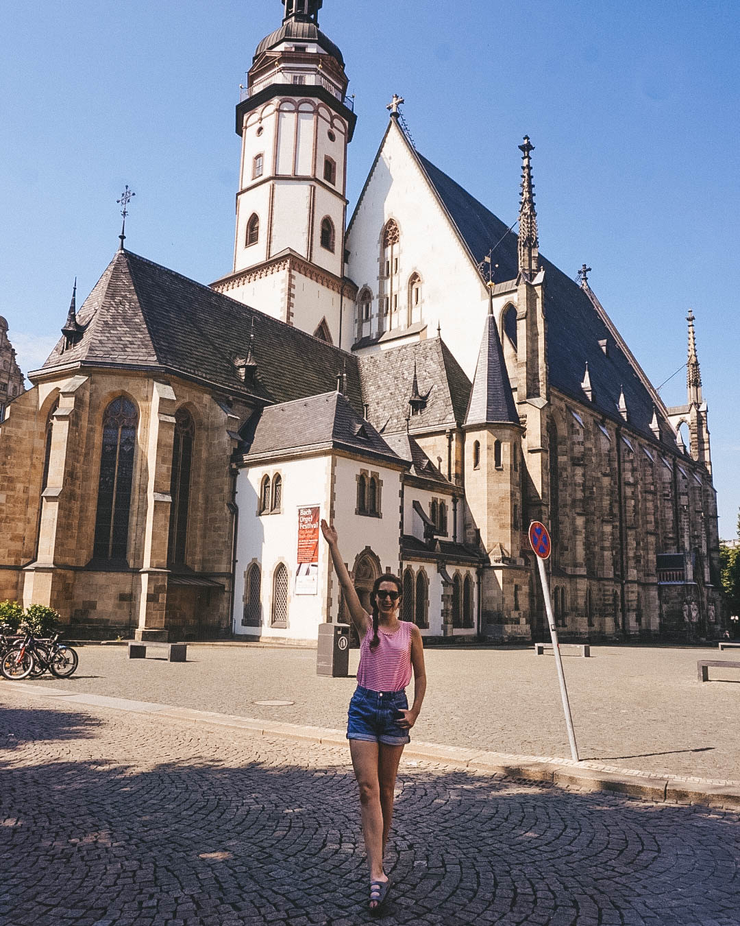 woman standing in front of St. Thomas Church in Leipzig