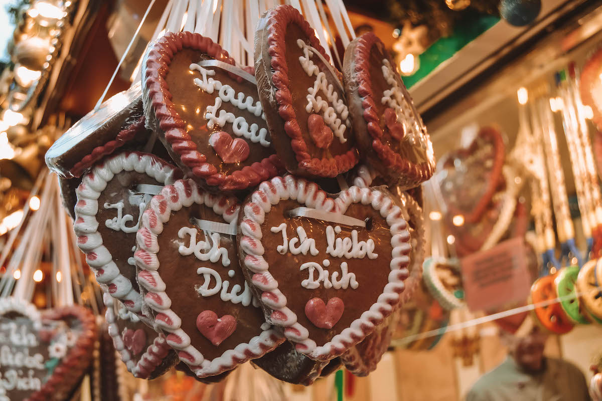 Gingerbread hearts hanging on the sides of a Christmas market stall