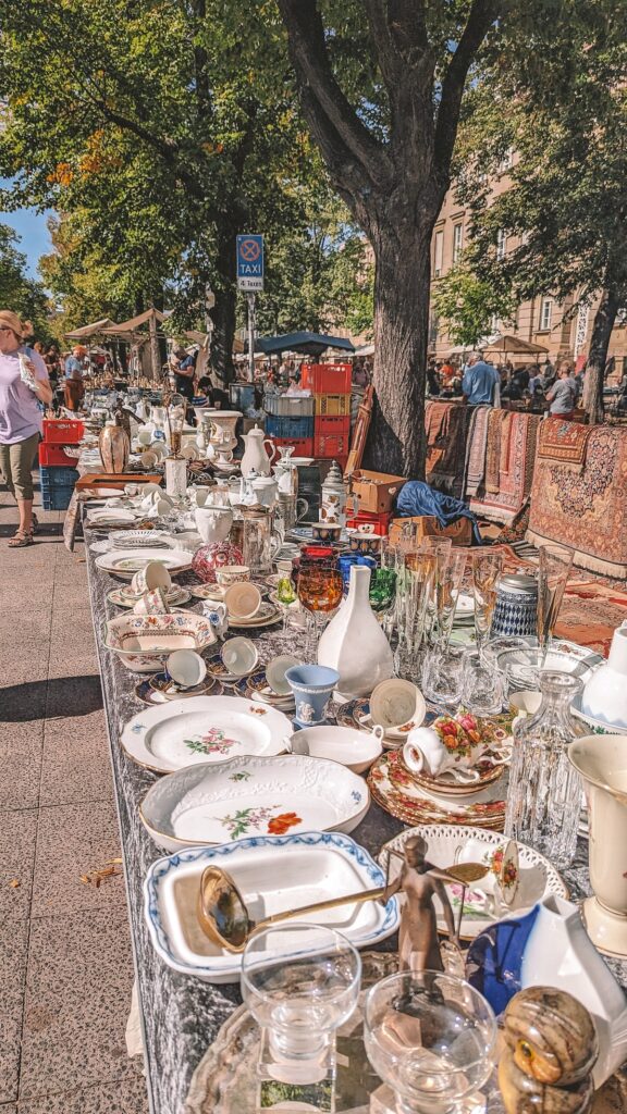 Goods laid out on tables at a Berlin flea market.