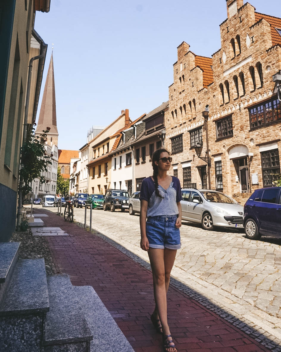 Woman walking down the street of Rostock Germany. 