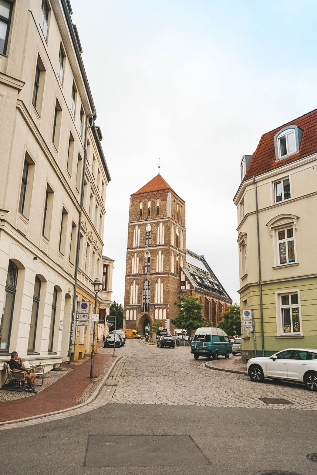 A view of the Nikolaikirche in Rostock, seen between buildings. 