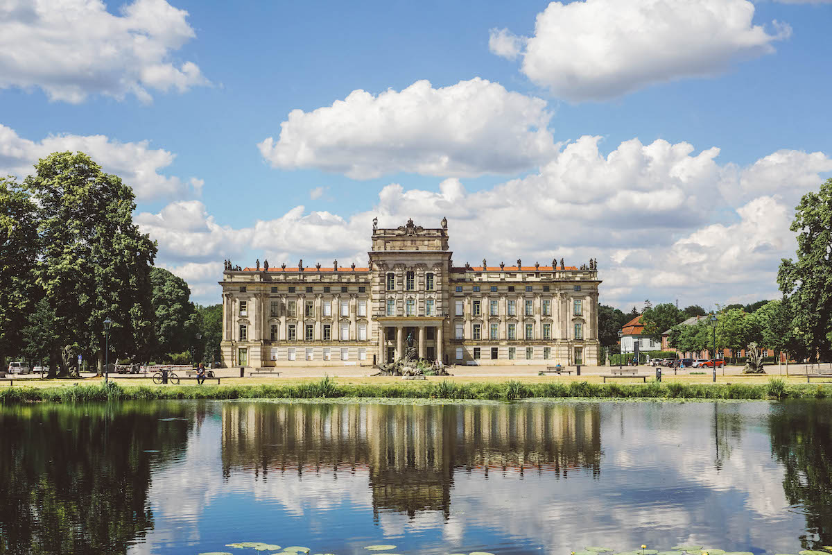 Ludwigslust Castle, with a reflecting pool in the foreground. 