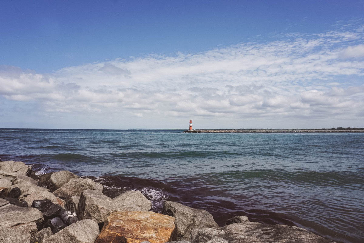 A lighthouse in Warnemünde, seen from across the water.