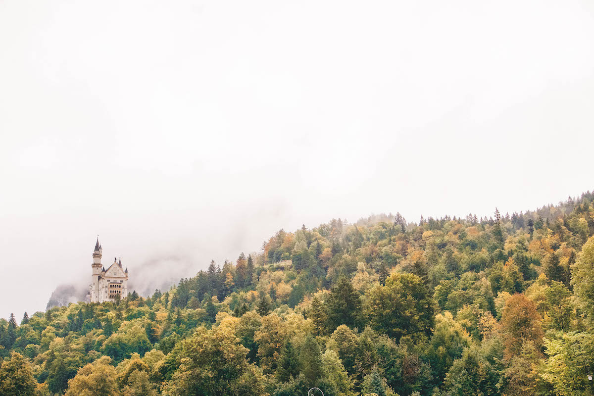 Neuschwanstein Castle seen in the distance through fog 