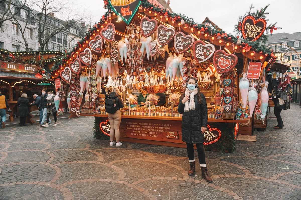 A woman standing in front of a Lebkuchen stall