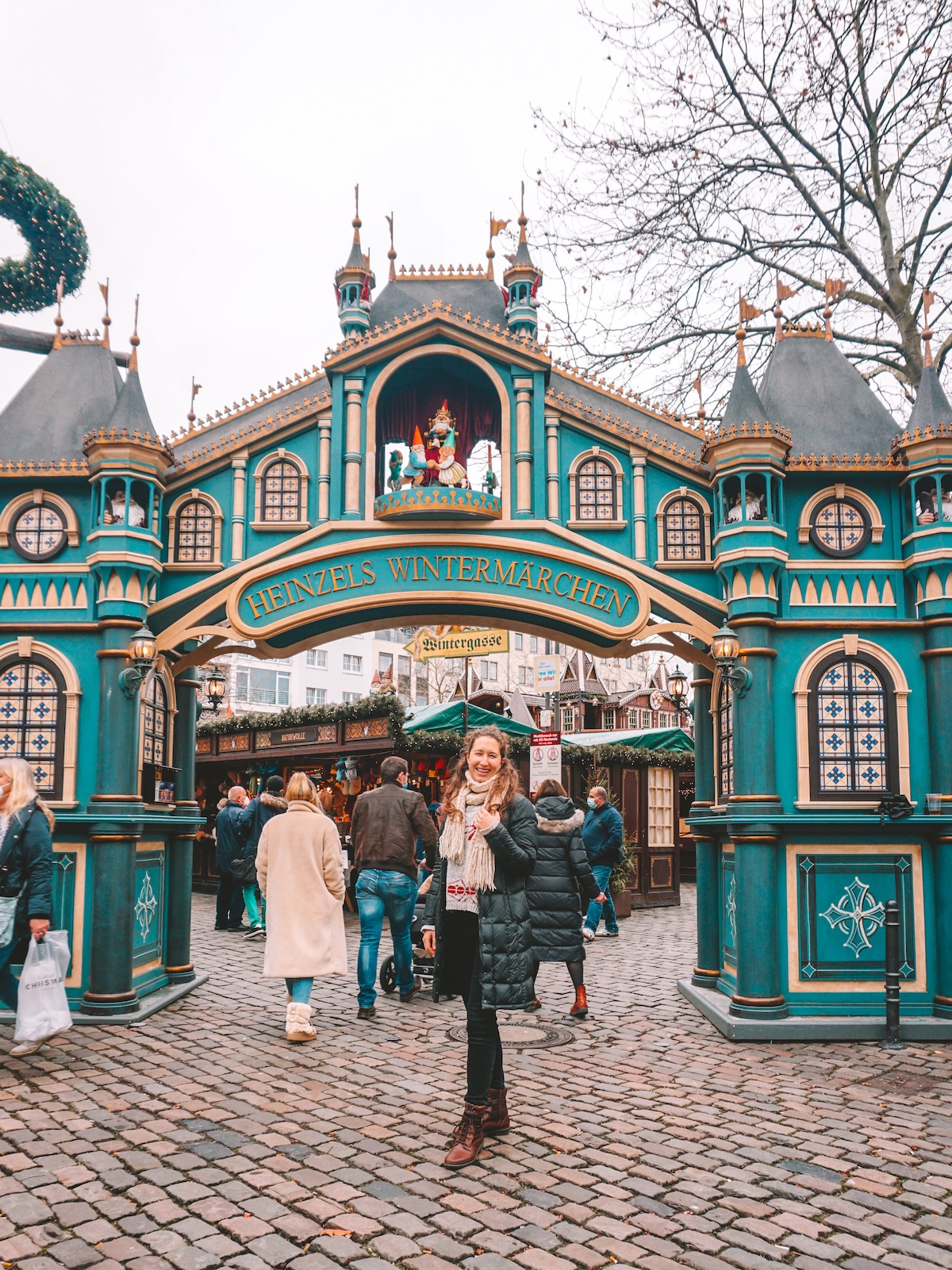Woman smiling in front of entrance to Heinzels Winter Fairytale