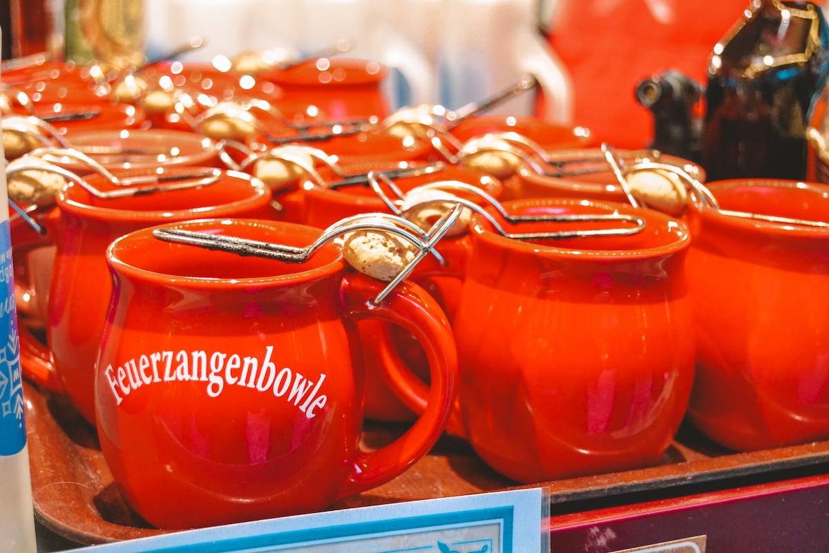 Red mugs with sugar cubes on top for Feuerzangenbowle. 