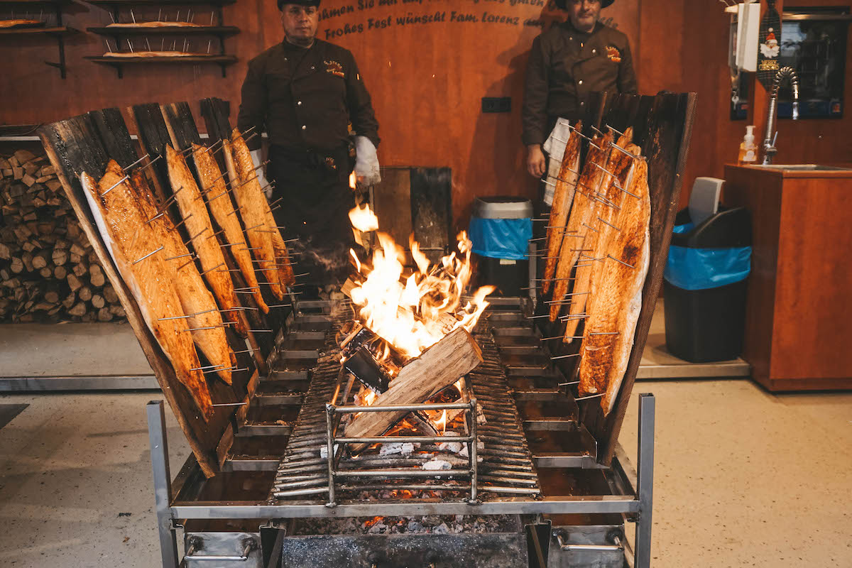 Salmon being cooked over a fire