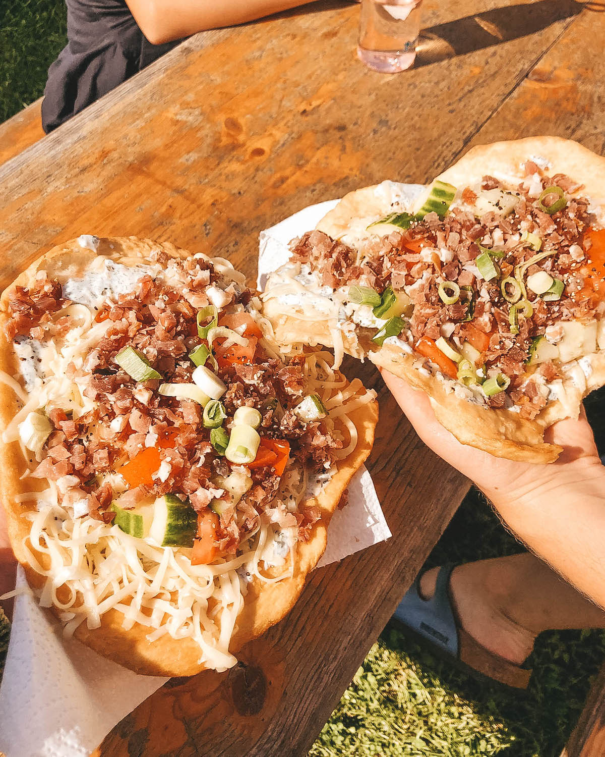 Two Hungarian Langos on a picnic table