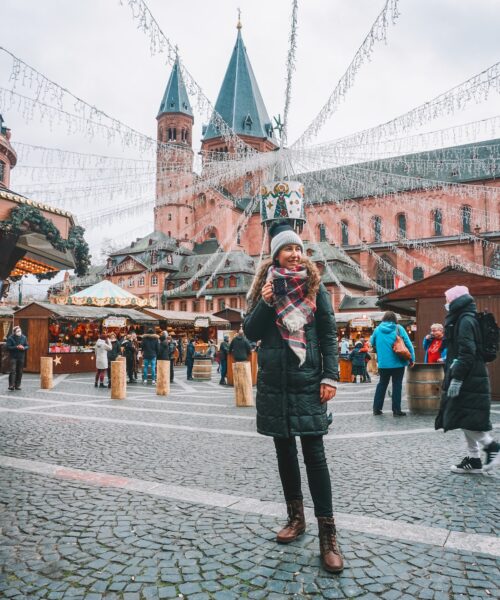 Woman smiling with mulled wine at Mainz Christmas market