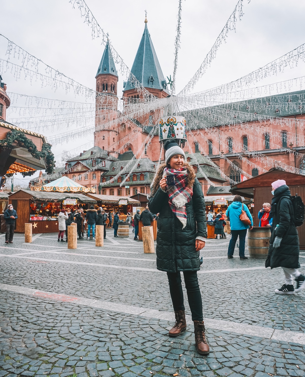 Woman smiling with mulled wine at Mainz Christmas market