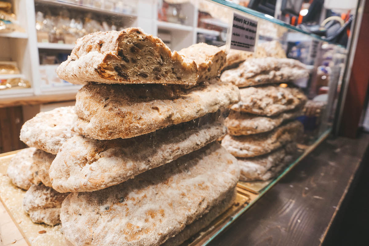 Loaves of stollen behind a glass case