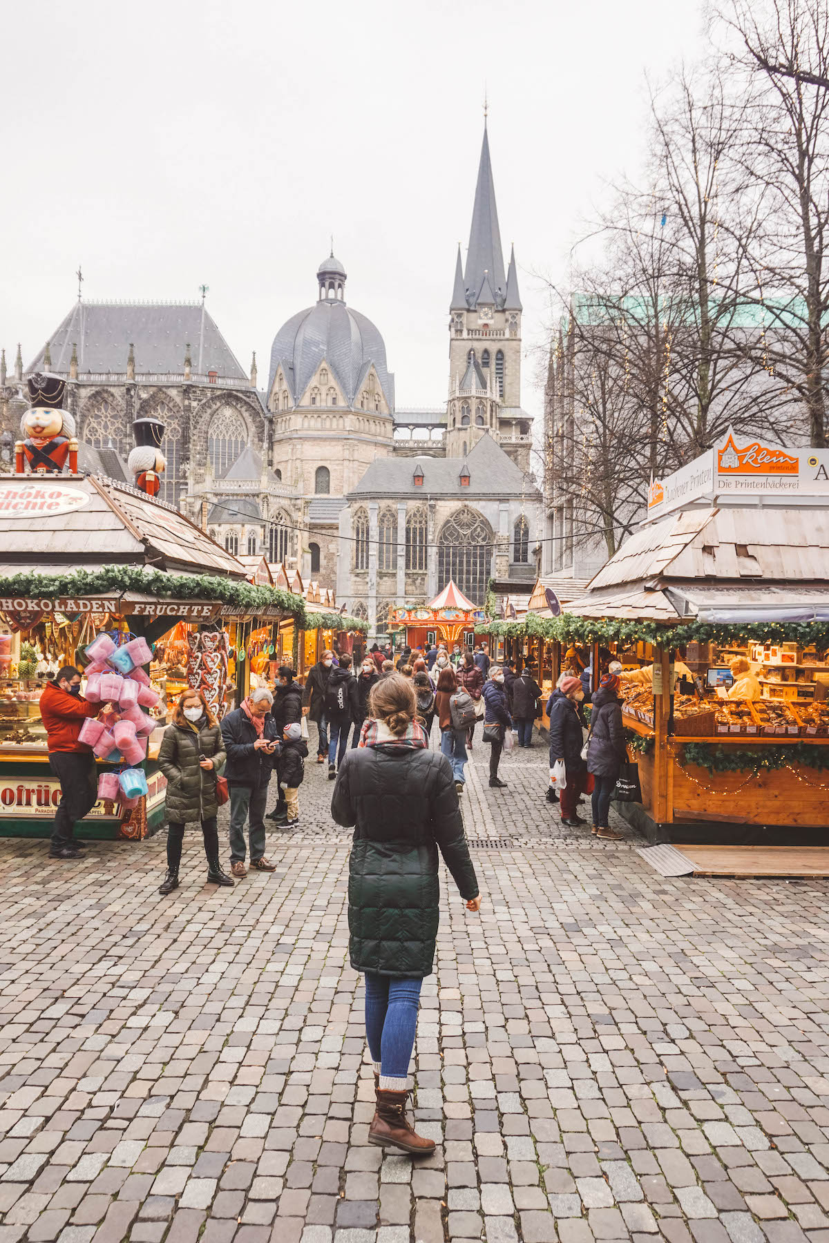 Woman standing with back to camera at Aachen Christmas market