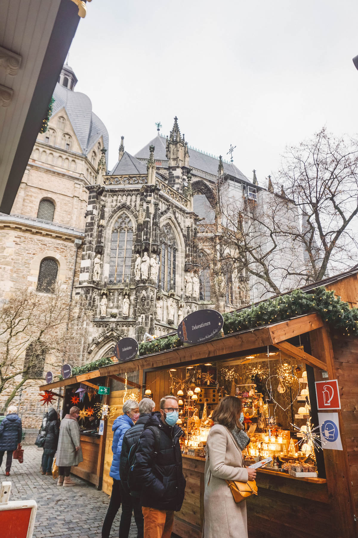 Christmas market stall with Aachen Cathedral in background