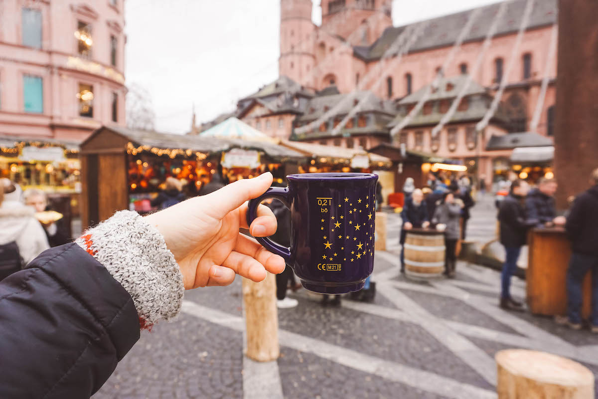 Christmas market mug being held aloft in Mainz