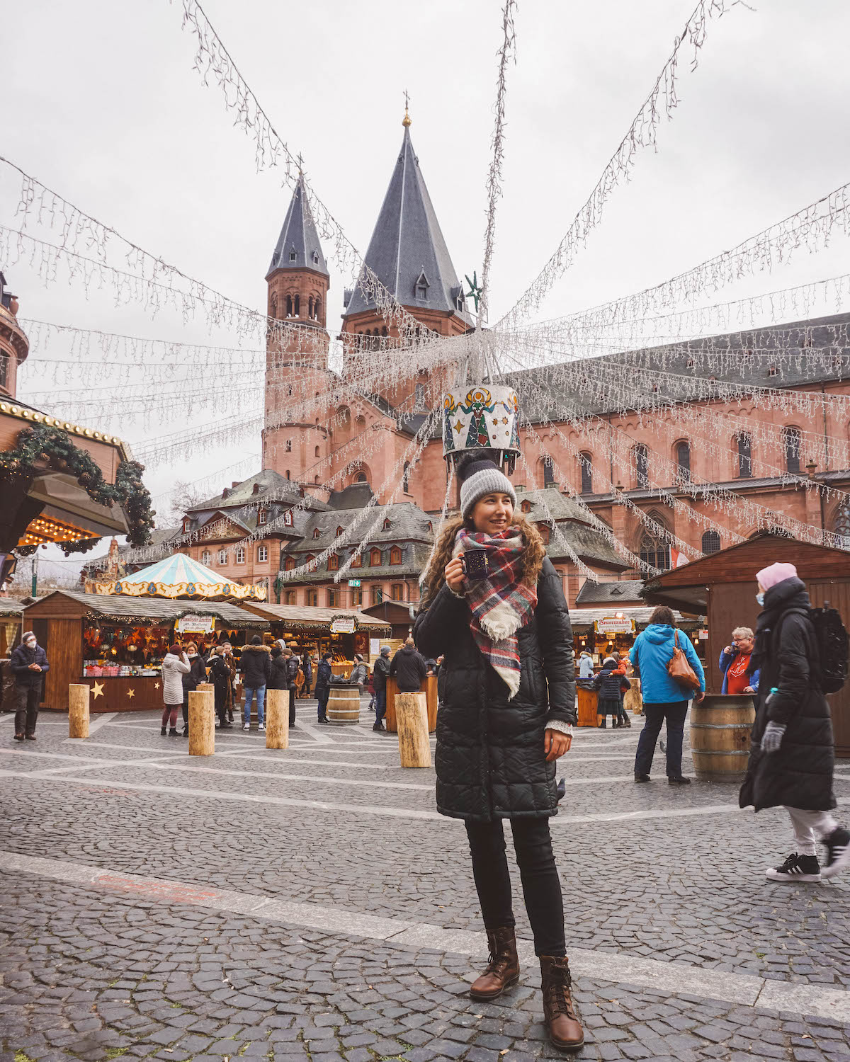 Woman holding mug at Mainz Christmas market