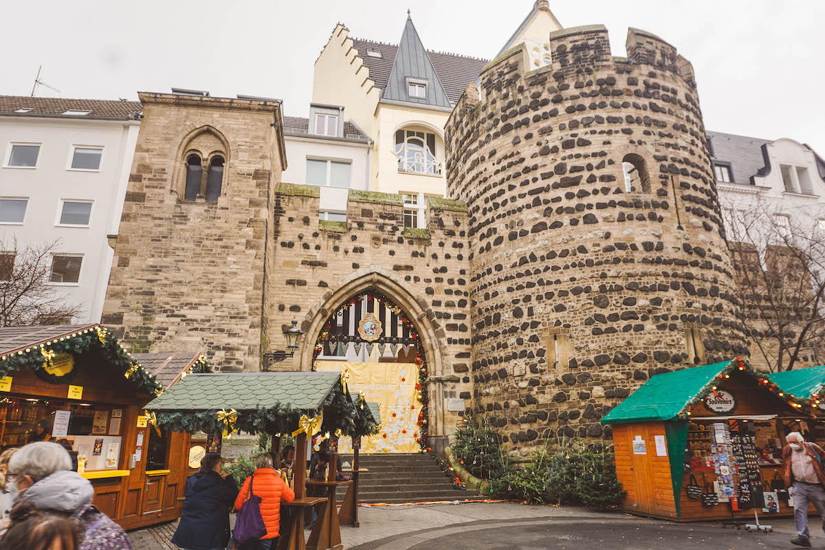 The Sterntor in Bonn, with Christmas market stalls surrounding it