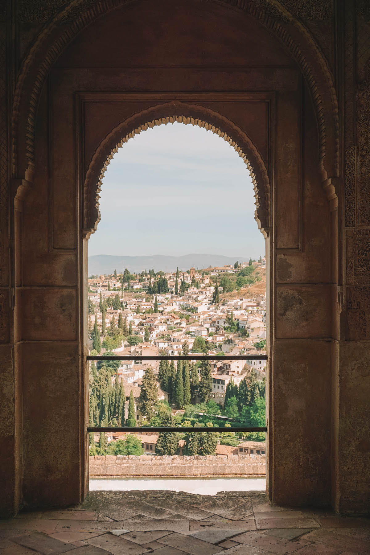 Horseshoe arch window in the Alhambra overlooking the Albaicin neighborhood.